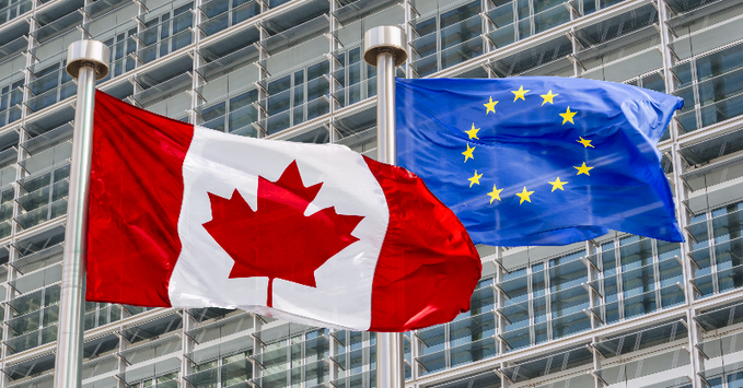 Canadian and European Union flags flying together — stronger EU–Canada partnership for promotional product exports. / Drapeaux du Canada et de l’Union européenne — un partenariat renforcé pour les exportations de produits promotionnels.